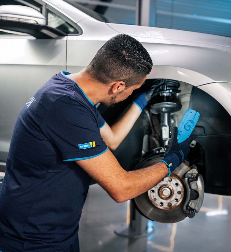 https://bilstein.com/wp-content/uploads/2022/06/Workshop-employee-checks-installed-BILSTEIN-shock-absorber-on-car.jpg