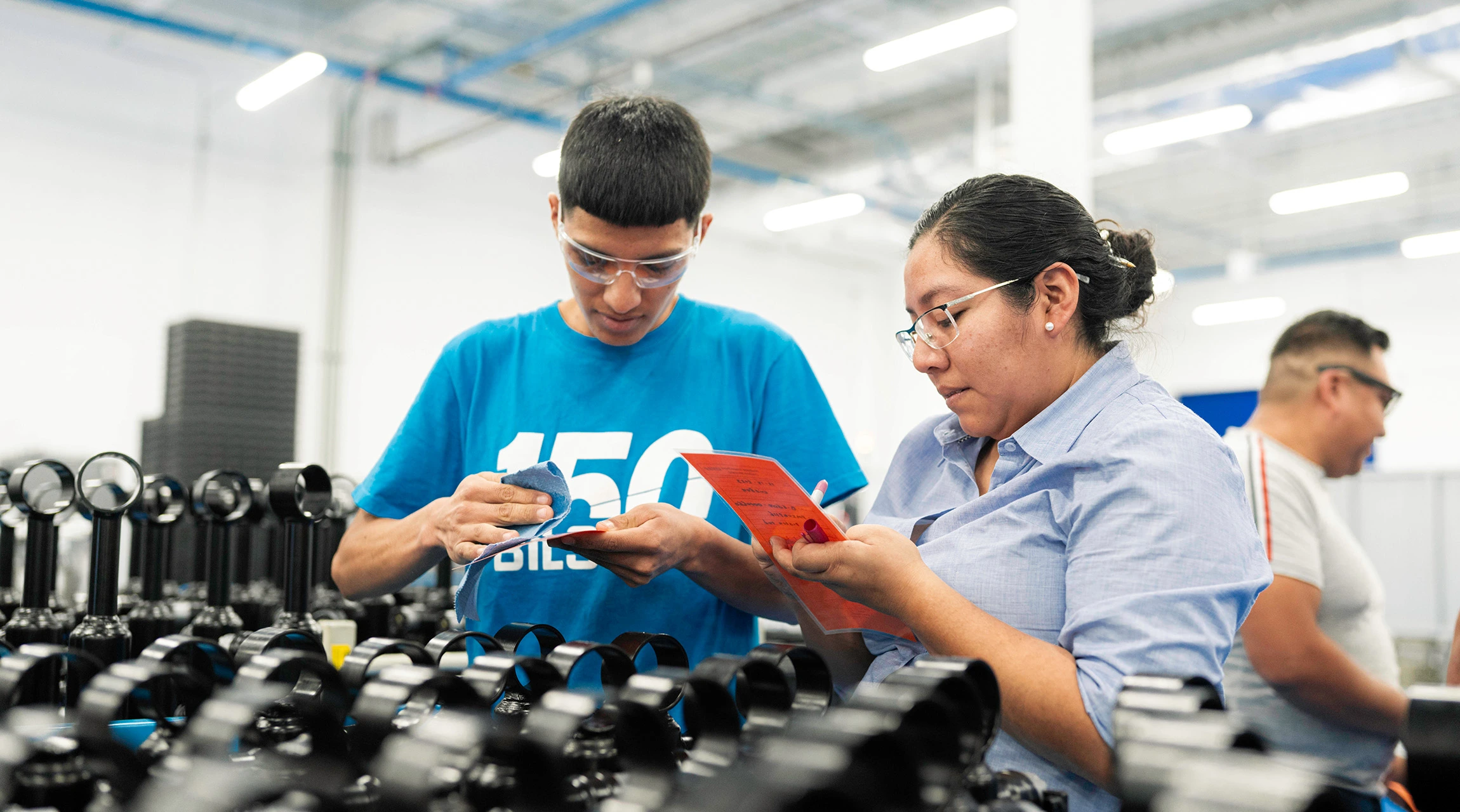 Two BILSTEIN employees inspect products at the factory.